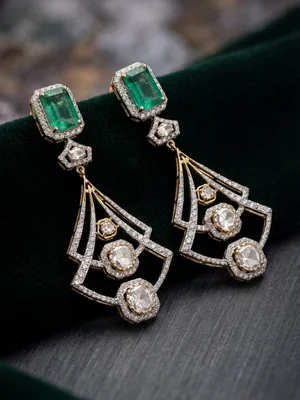 Emerald and diamond chandelier earrings on dark velvet