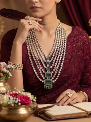 Layered strands on a model in maroon, close detail of the knotting and drops