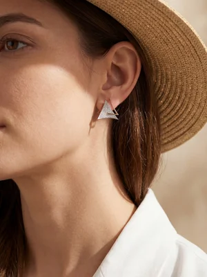 Triangle earring on a model in a straw hat