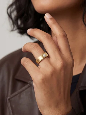 Gold band on a hand, close crop