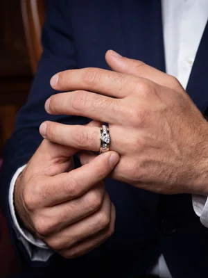 White-metal band on a man's hand at his shirt cuff