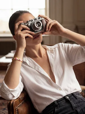 Bracelet on a model holding a vintage camera