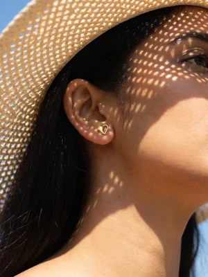 Ear climber on a model in dappled straw-hat light
