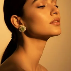 Green gemstone stud on a model in golden-hour profile