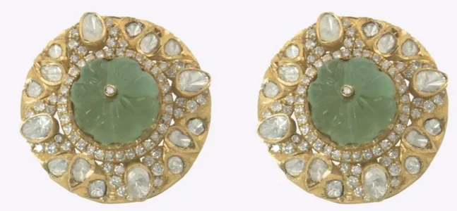 Packshot of a pair of green cabochon studs with a white-stone halo, as the brand sent it
