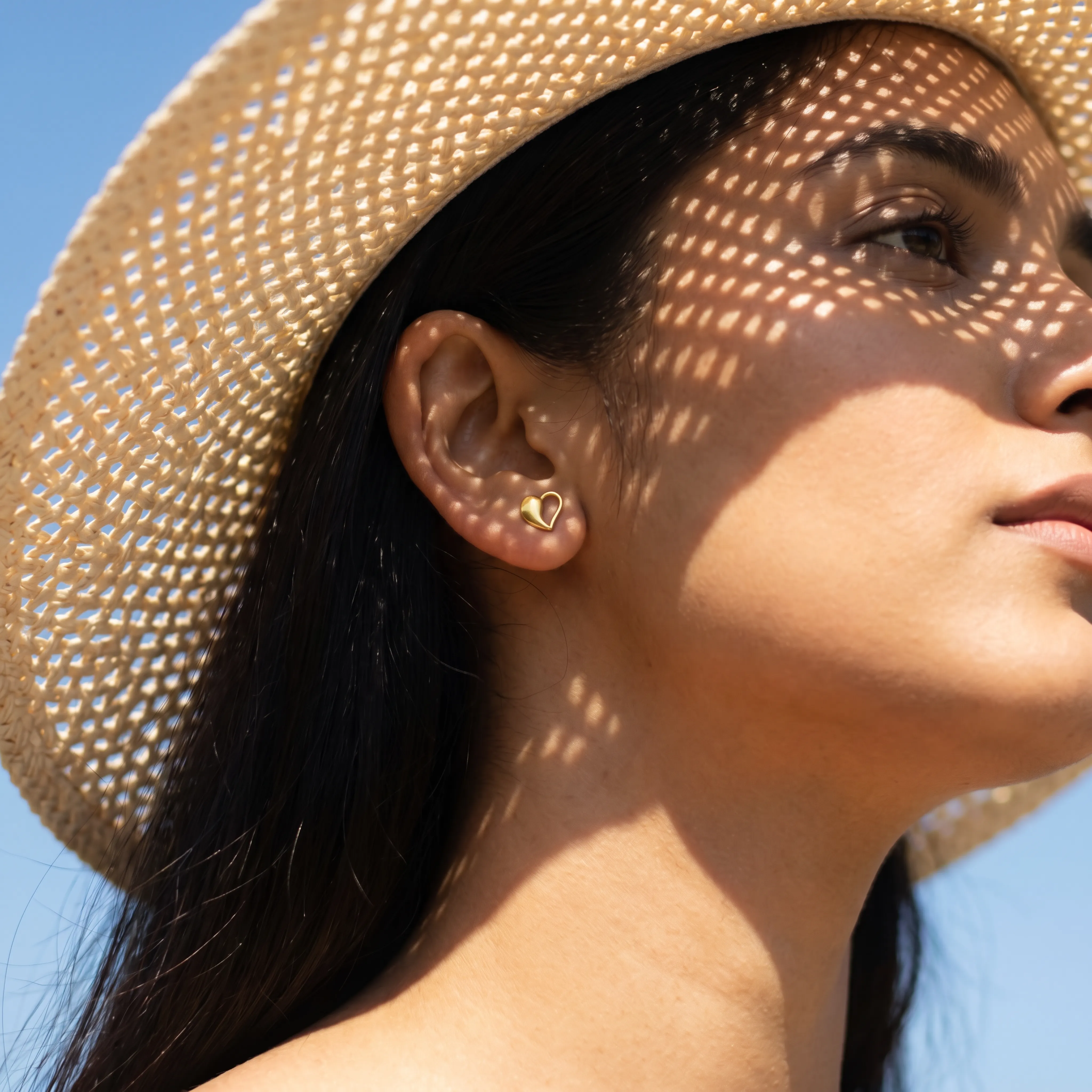 AI lifestyle model in sun hat wearing Ghare heart studs