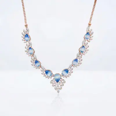 Blue-stone necklace laid flat on a white sweep