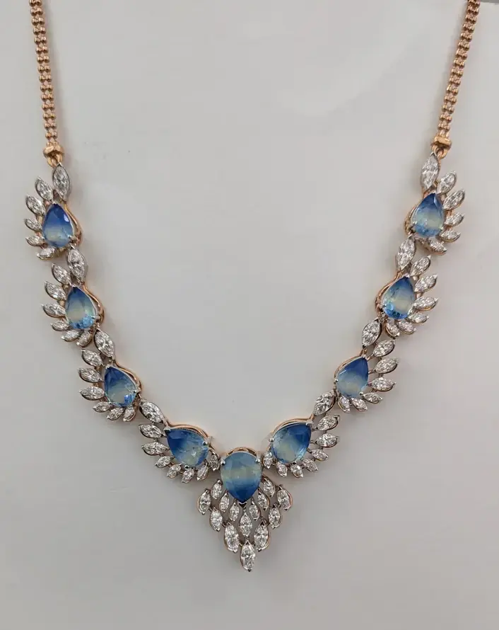 Phone photo of a blue-stone necklace laid on a grey cloth, as the brand sent it