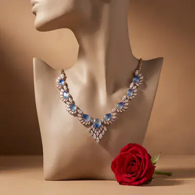 Blue-stone necklace on a sculpted bust with a red rose