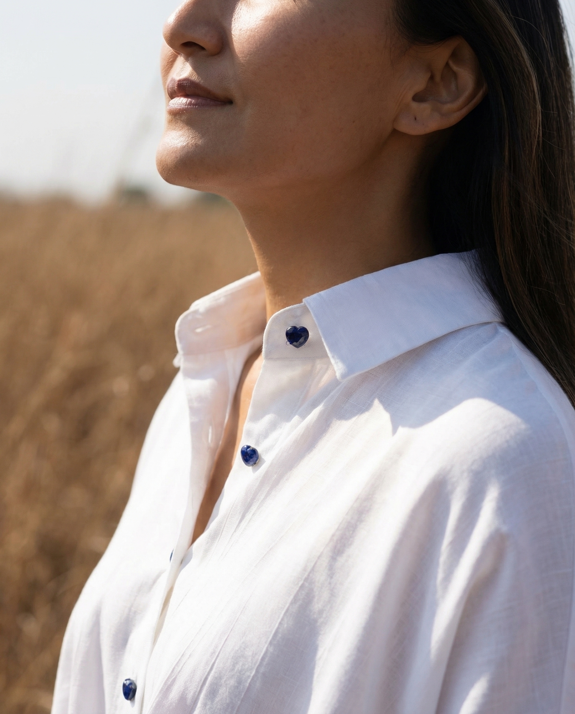 Close-up of The K Way collar with blue lapis heart gemstone buttons