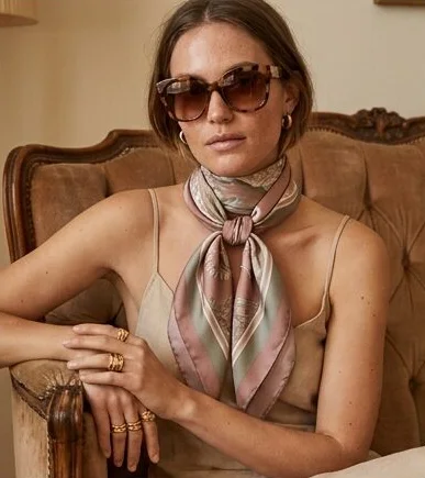 Accessories look on a model seated in a leather armchair indoors, an AI photoshoot by Kaptured.AI