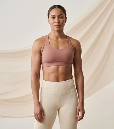 Activewear look on a model against a draped linen backdrop, an AI photoshoot by Kaptured.AI