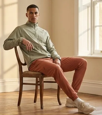 Activewear look on a model seated in a leather armchair indoors, an AI photoshoot by Kaptured.AI