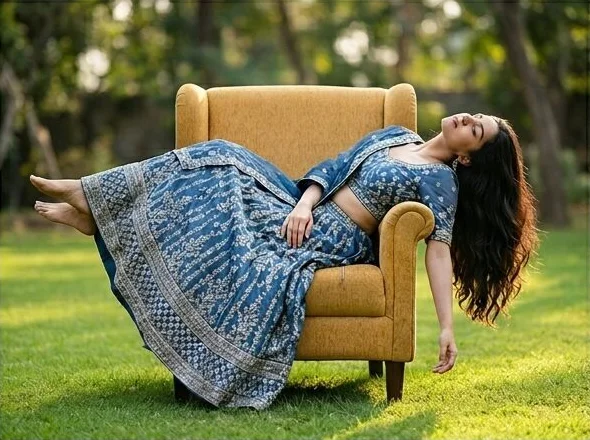 The same ethnic wear look in a second armchair pose, shot with AI