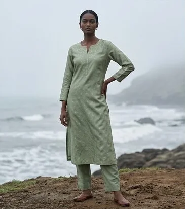 Ethnic wear look on a model on a misty rocky coastline, an AI photoshoot by Kaptured.AI