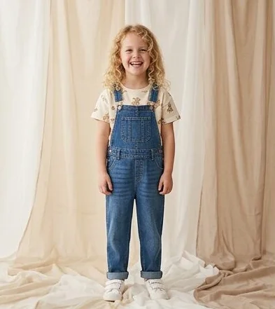Kidswear look on a model against a draped linen backdrop, an AI photoshoot by Kaptured.AI