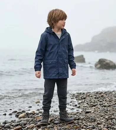 Kidswear look on a model on a misty rocky coastline, an AI photoshoot by Kaptured.AI