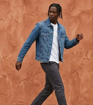 Menswear look on a model moving past a terracotta wall, an AI photoshoot by Kaptured.AI