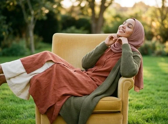 Modest wear look on a model lounging in a garden armchair, shot with AI