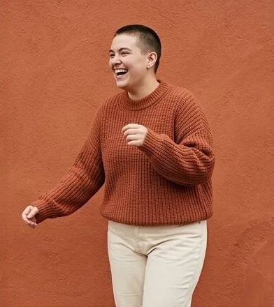 Plus-size look on a model moving past a terracotta wall, an AI photoshoot by Kaptured.AI
