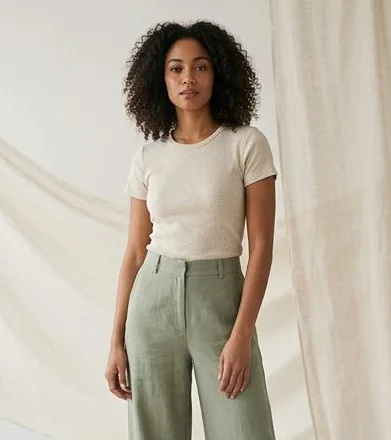 Sustainable fashion look on a model against a draped linen backdrop, an AI photoshoot by Kaptured.AI