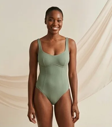 Swimwear look on a model against a draped linen backdrop, an AI photoshoot by Kaptured.AI