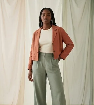 Womenswear look on a model against a draped linen backdrop, an AI photoshoot by Kaptured.AI