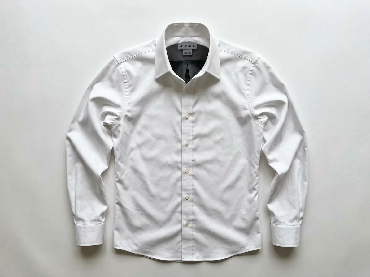 Ghost mannequin photo of a white cotton poplin shirt with a point collar on white, made with AI