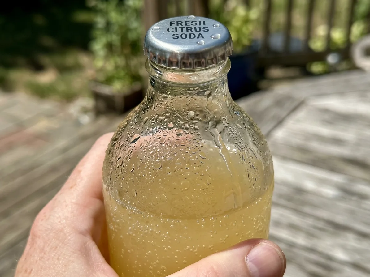 Close-up of condensation running down the bottle's shoulder, made with AI