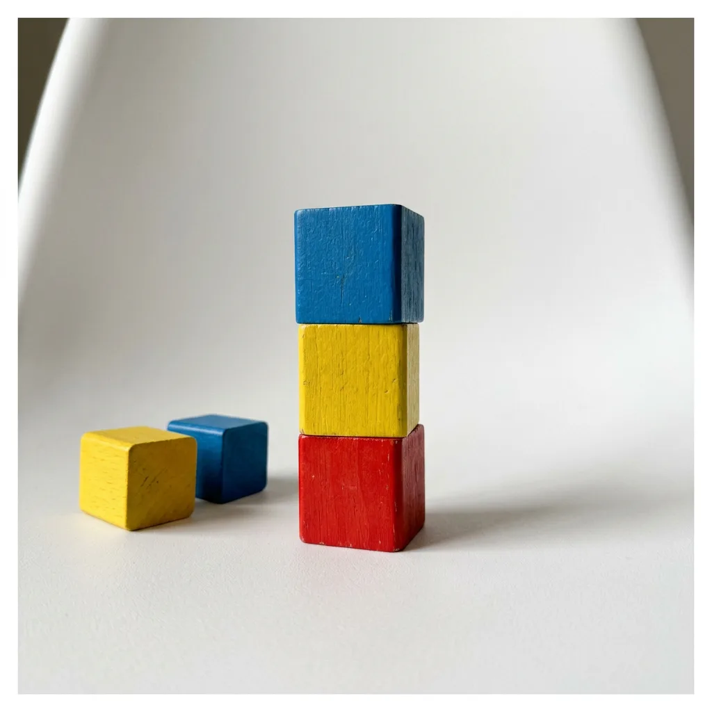 The stacking blocks on white, a short tower with two blocks beside it, made with AI