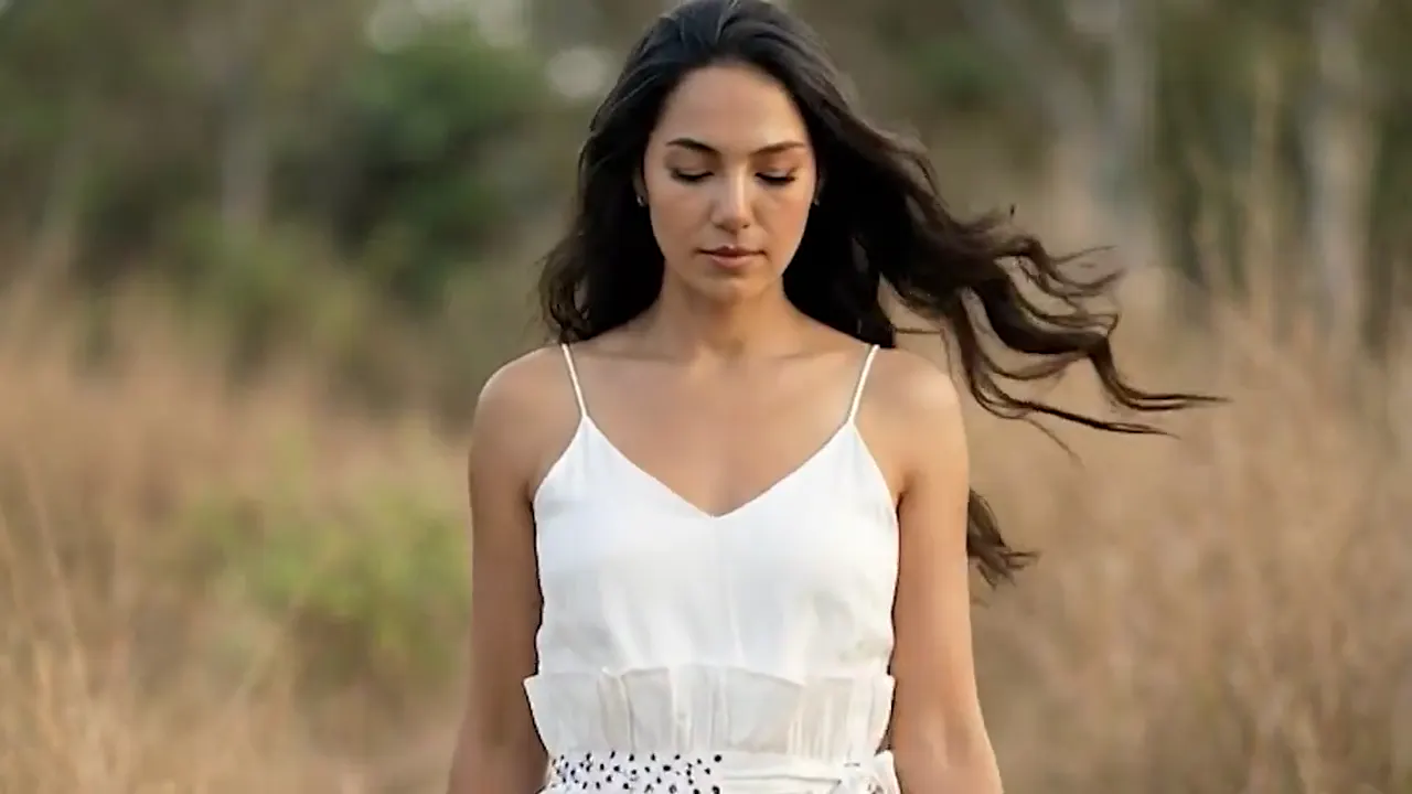 Hair mid-swing at a scene transition in an AI commercial